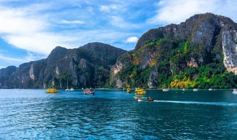 a group of boats sailing on a body of water