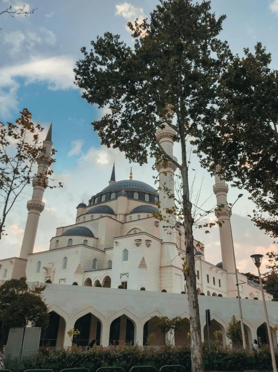 a white building with towers and a clock at the top of it