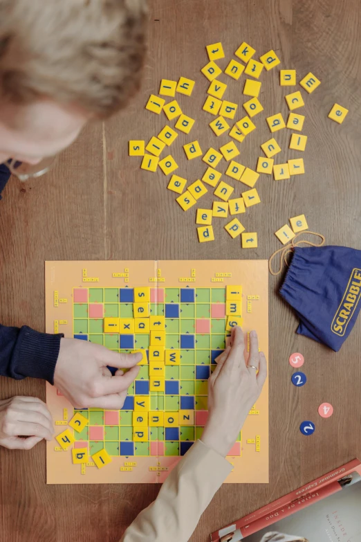 a woman and boy playing board games on a table