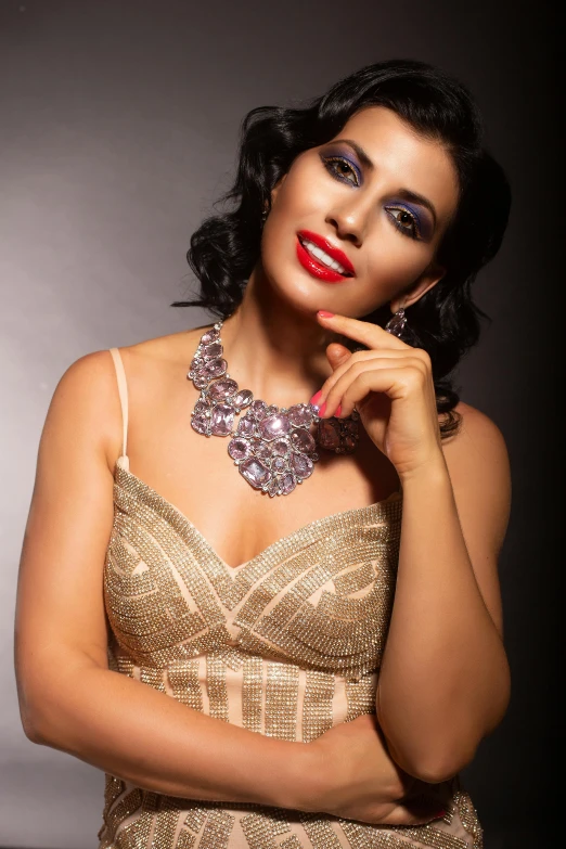 a young woman posing for a picture wearing a formal dress and a spark necklace