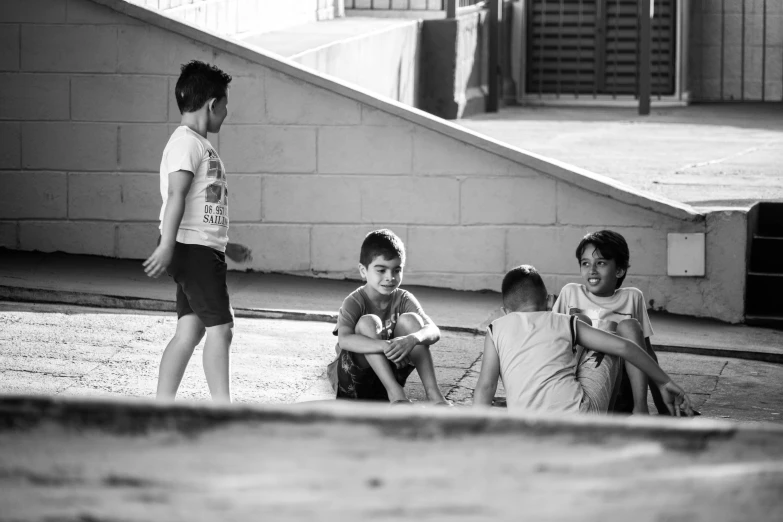 a boy and his friends sit on the ground together