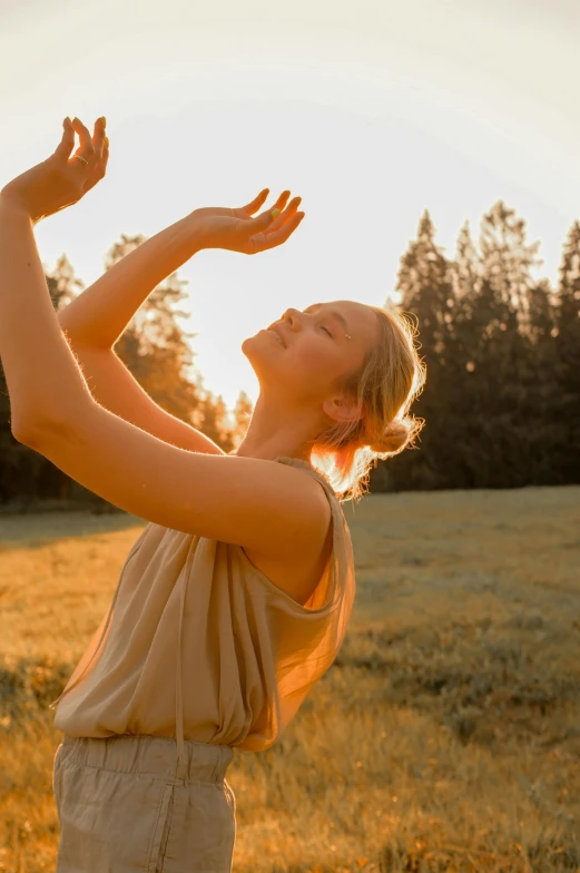 a beautiful young woman standing in a field