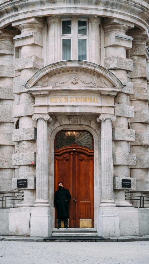 a man is standing in front of the door of a building