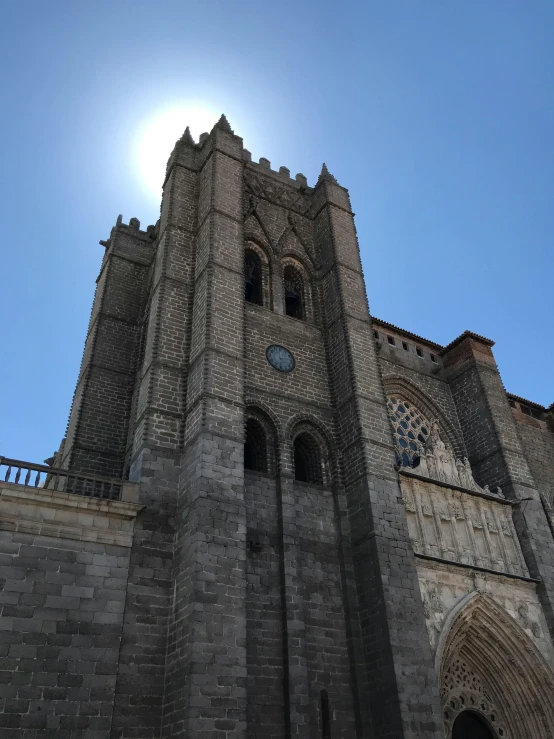 the sun shines brightly through an ornate stone building