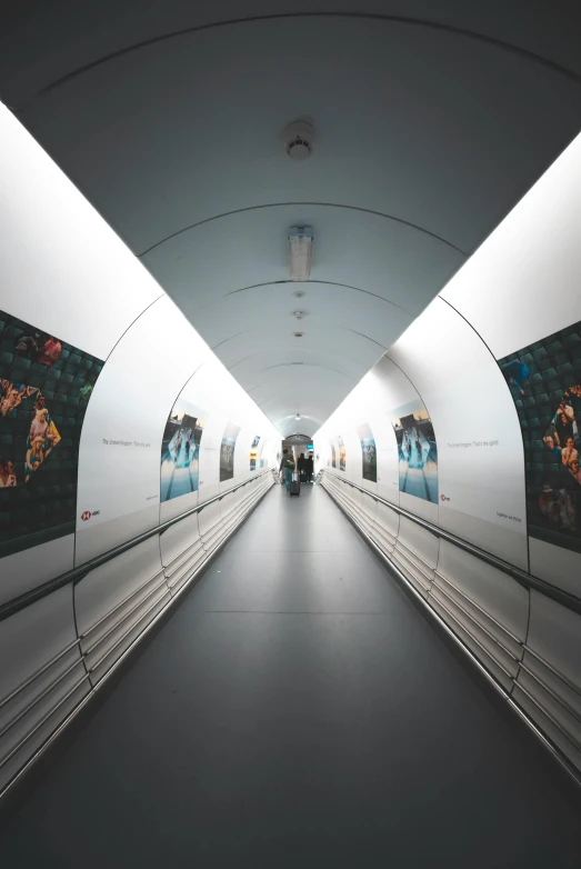 a subway platform has its lights on and people in the background