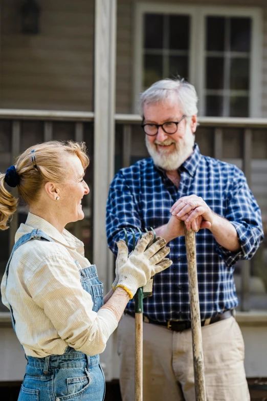 a man and woman dressed in period clothing and glasses