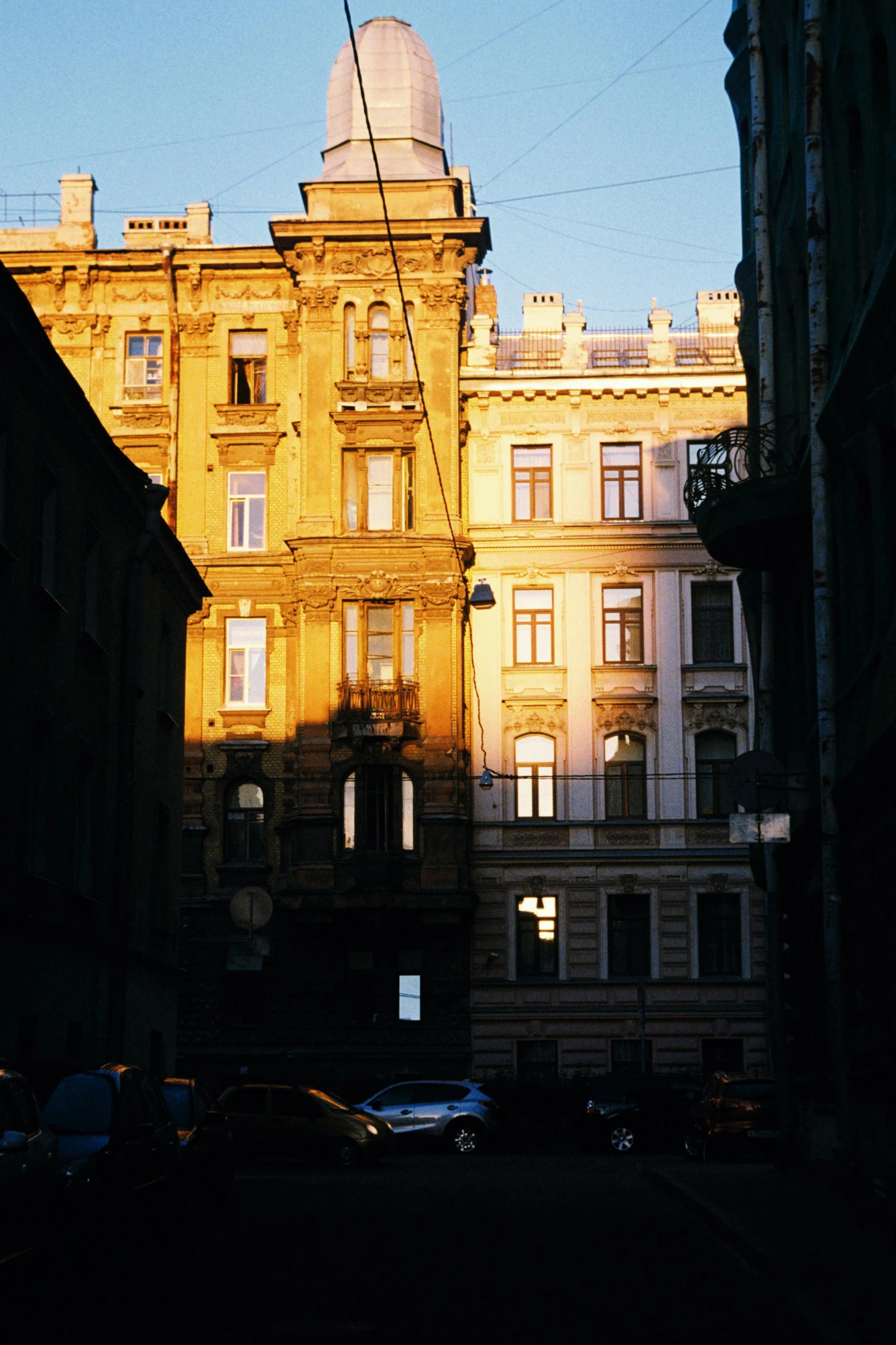 the silhouette of tall buildings stands next to a street