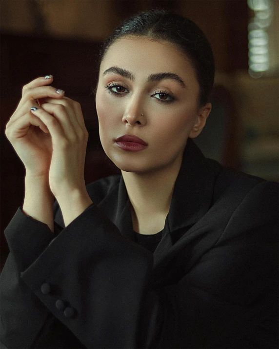 a beautiful woman with a red lipstick and smoky eyeshadow posing for the camera