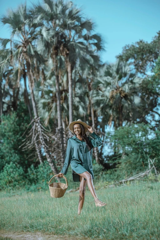 a person wearing a hat standing in grass