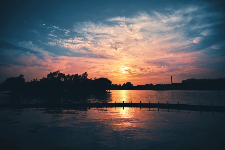 a sunset that is glowing and some water