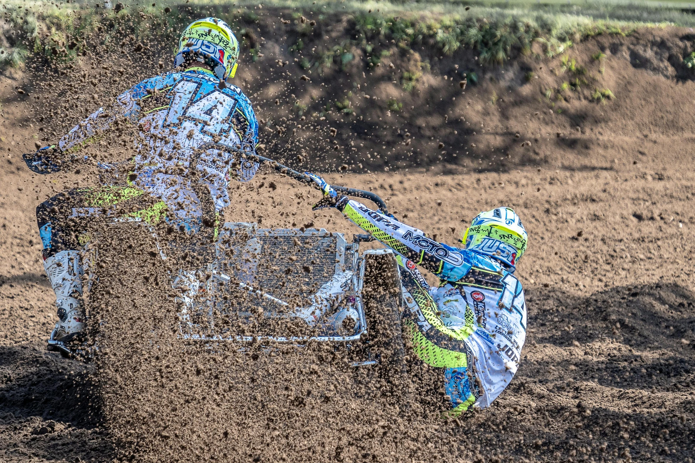 a dirt bike rider sliding down a hill