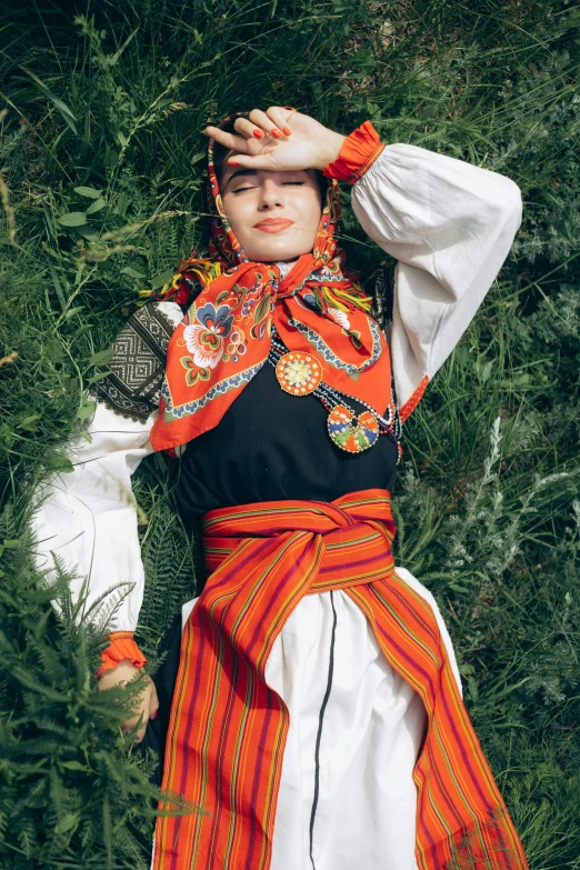 an attractive young woman posing in a field of grass