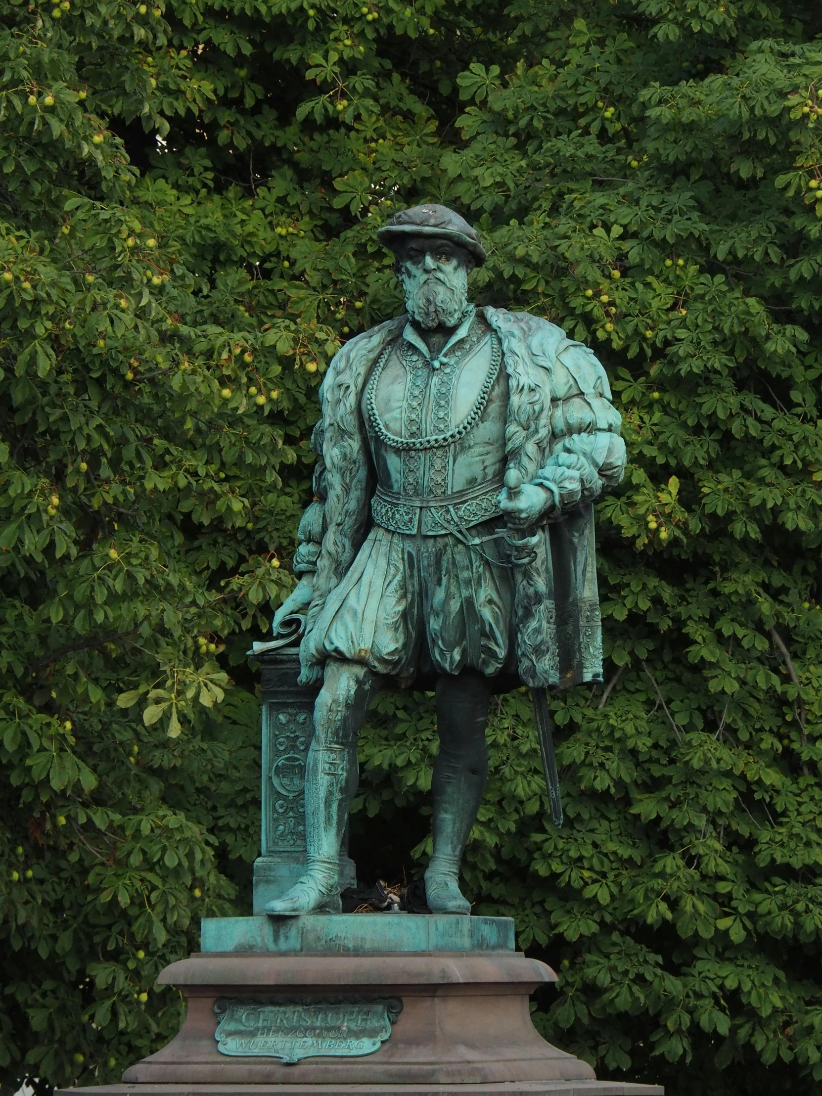 a green statue of a man holding a briefcase