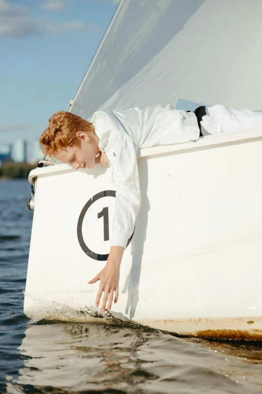 a red headed woman wearing white on a boat in the water