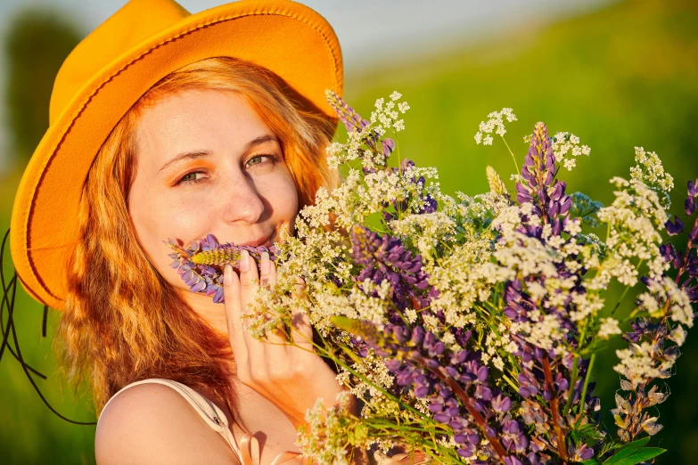 woman with flowers wearing a yellow hat