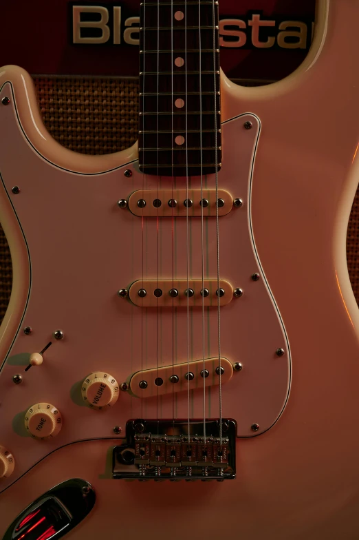 a closeup view of a pink and black guitar