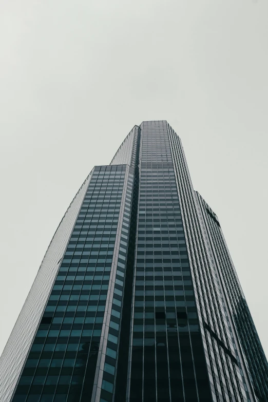 a tall building stands against the sky on a hazy day