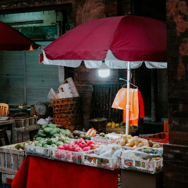 a fruit and vegetable stand in the middle of a street