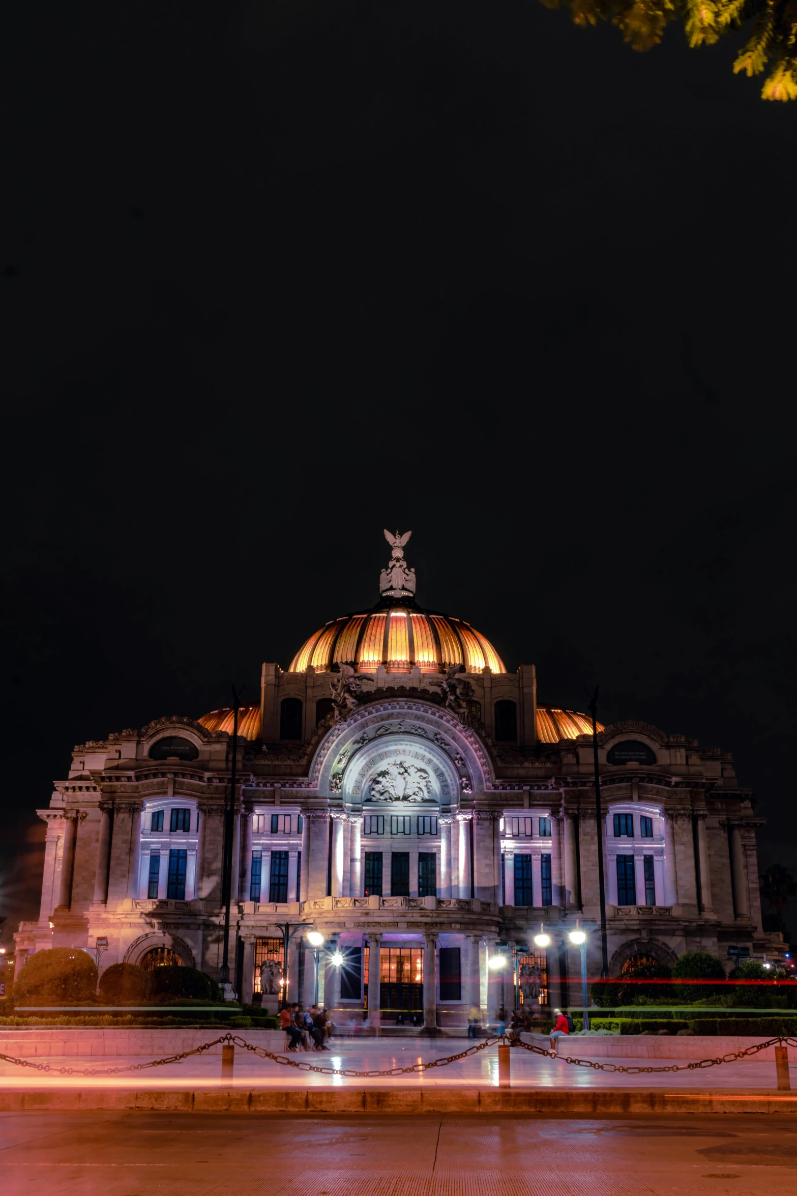 a building lit up with lights is seen in the evening