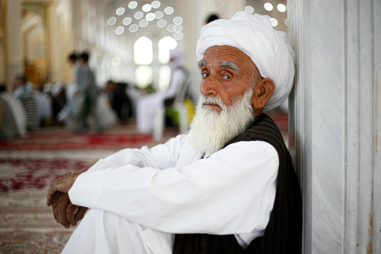 an old man sitting in the middle of the room