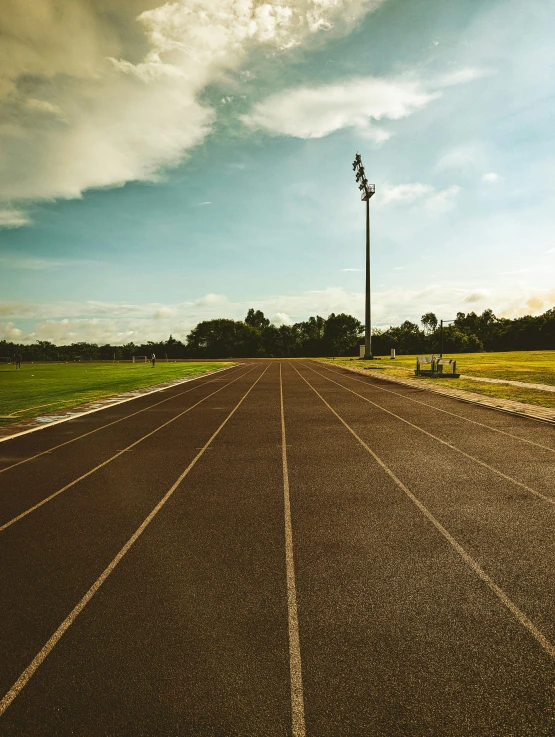 the asphalt is brown and there are many poles