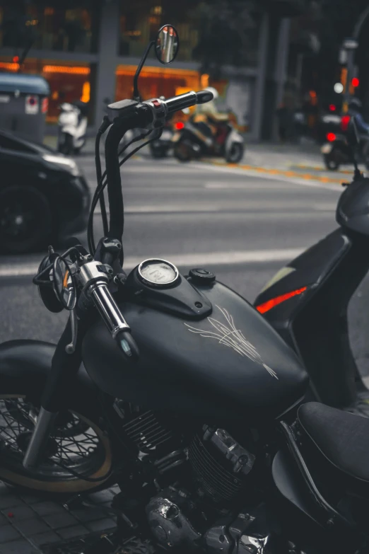 a motorcycle parked along the sidewalk in the city