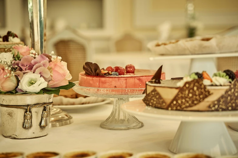 various desserts sit on display in an elegant setting