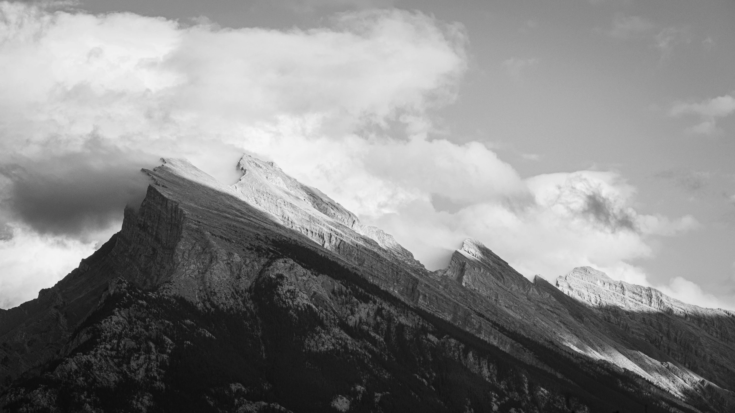 some very tall mountains with clouds on top