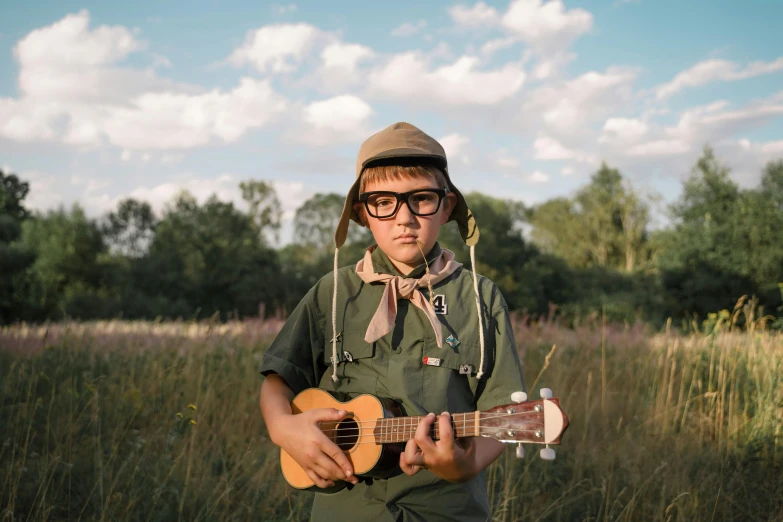 a man in the woods playing an acoustic guitar