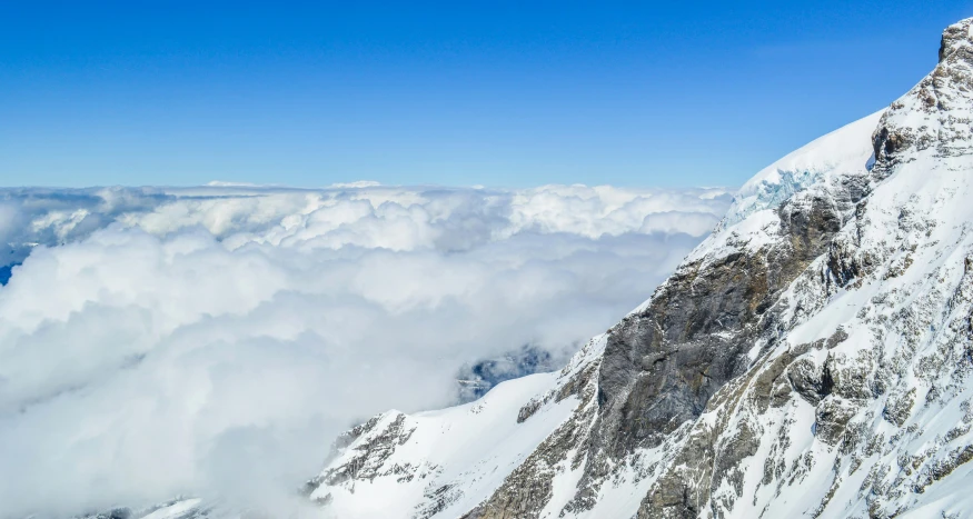 a snow covered mountain is shown from the air