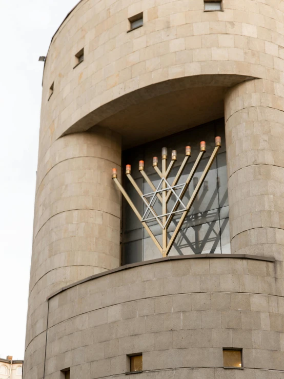 a large white clock tower with candles in it's windows