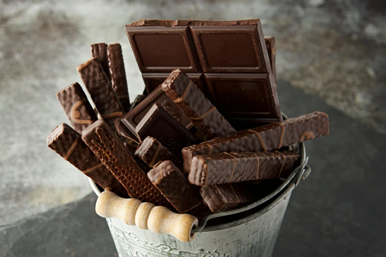 a large amount of chocolate sticks stacked in a cup