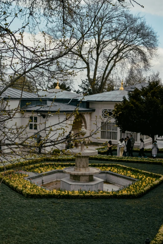 a view from outside of a building with a fountain in the middle