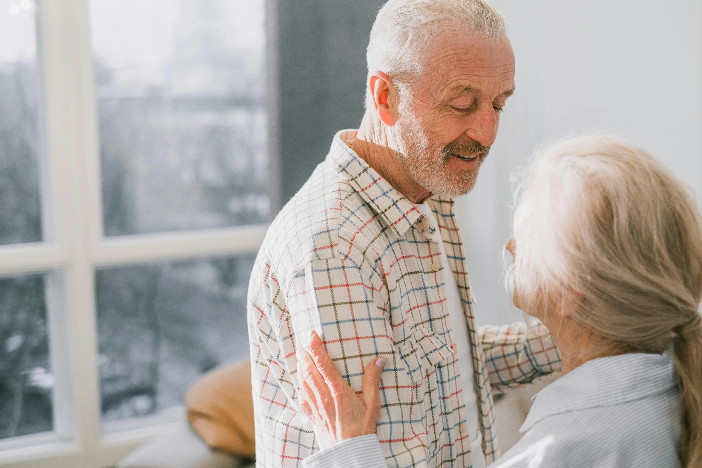 a woman is talking to an older man