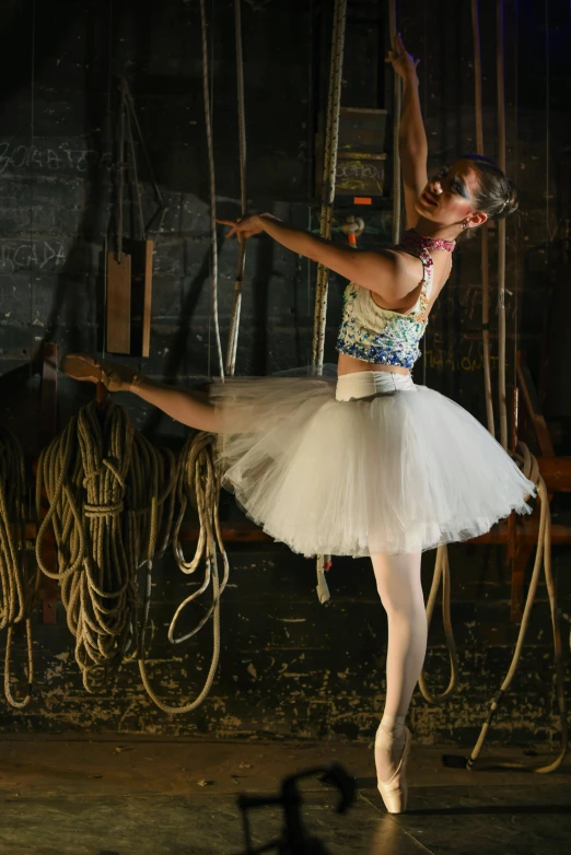 a ballerina is practicing in a barn