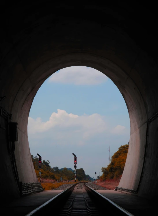 the inside of a tunnel has train tracks leading to it