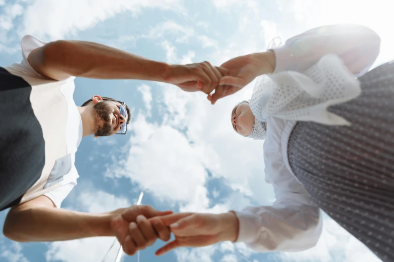 two people standing with their hands in the air