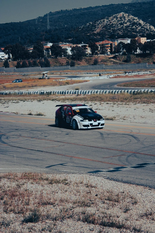 two dirt racing cars parked on the street