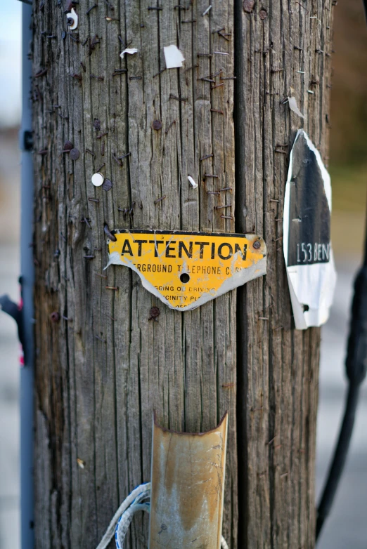 the sign is affixed to the wooden post