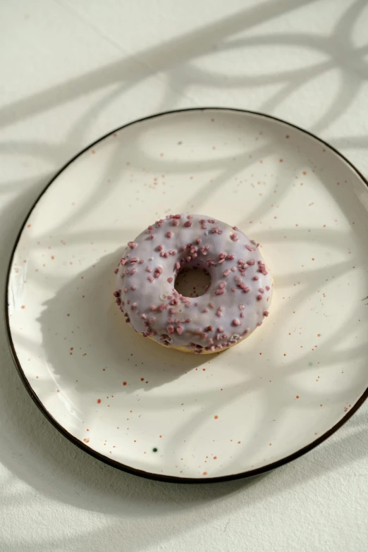 this donut has sprinkles on it and is ready to be eaten