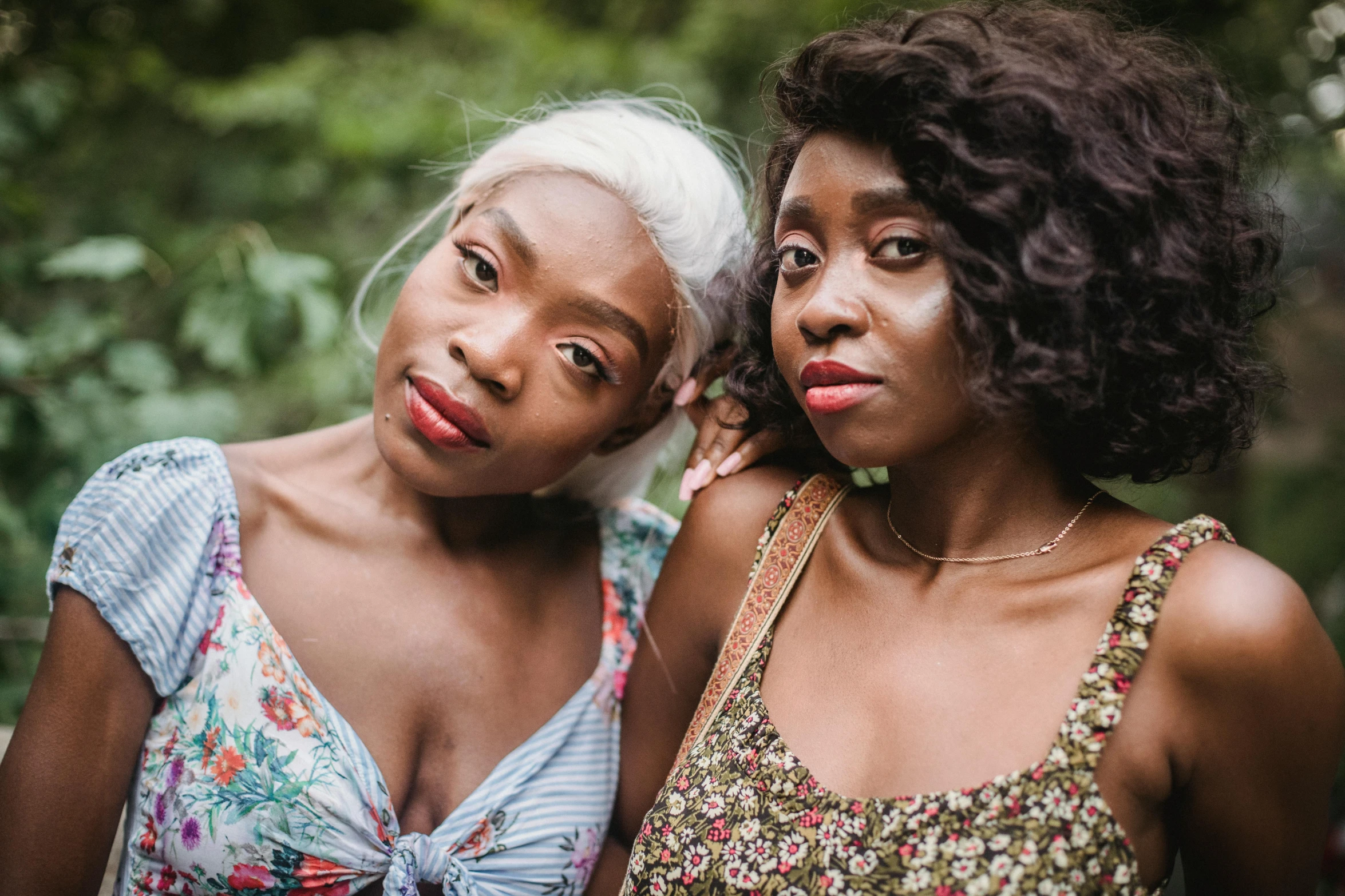 two women in colorful dresses stand near each other