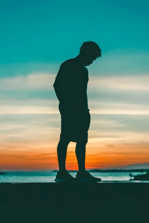 a man standing on top of a sandy beach near the ocean