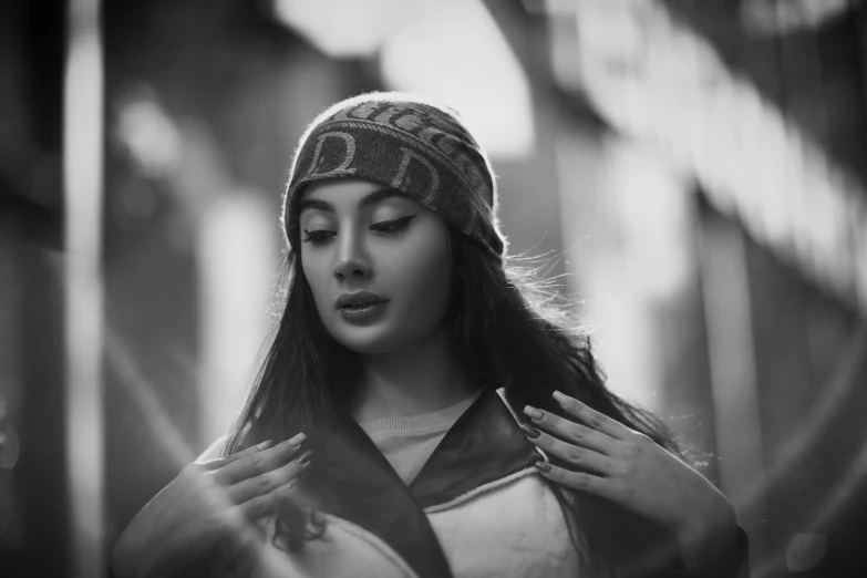 woman wearing a hat standing next to some railing