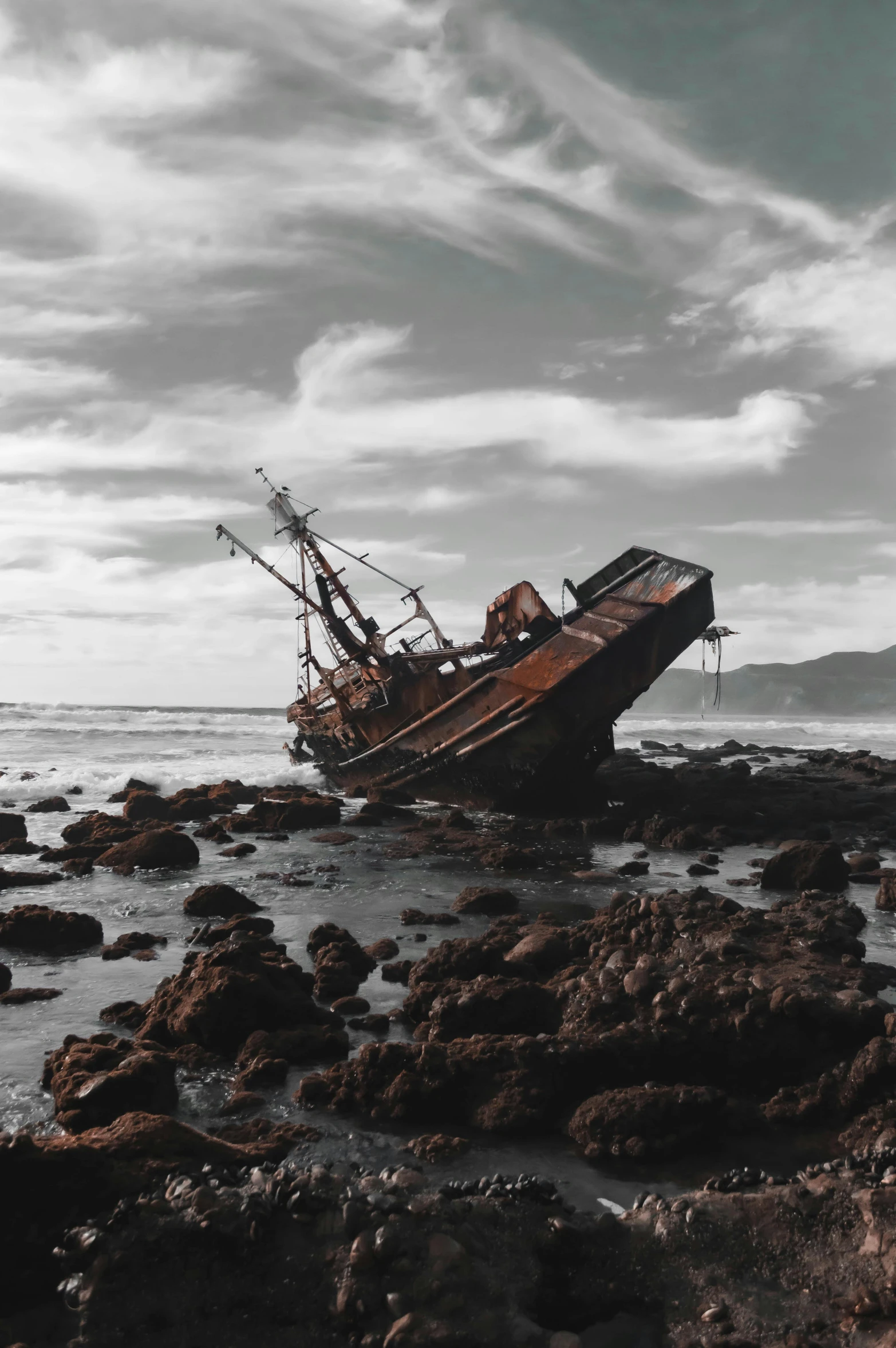 a boat is sitting on its side in some rocks