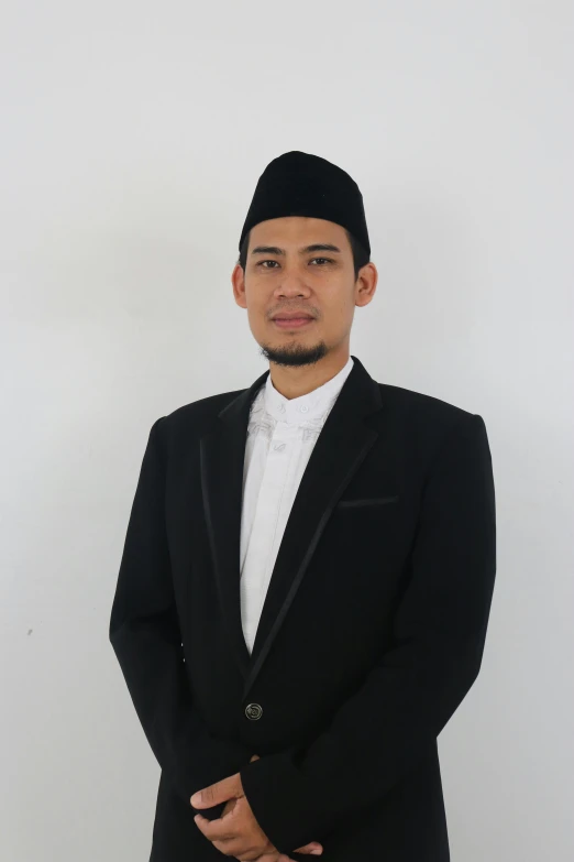 a man standing in front of a white background