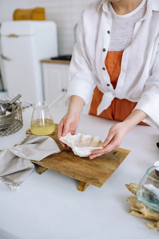 a woman is making a pastry at a table