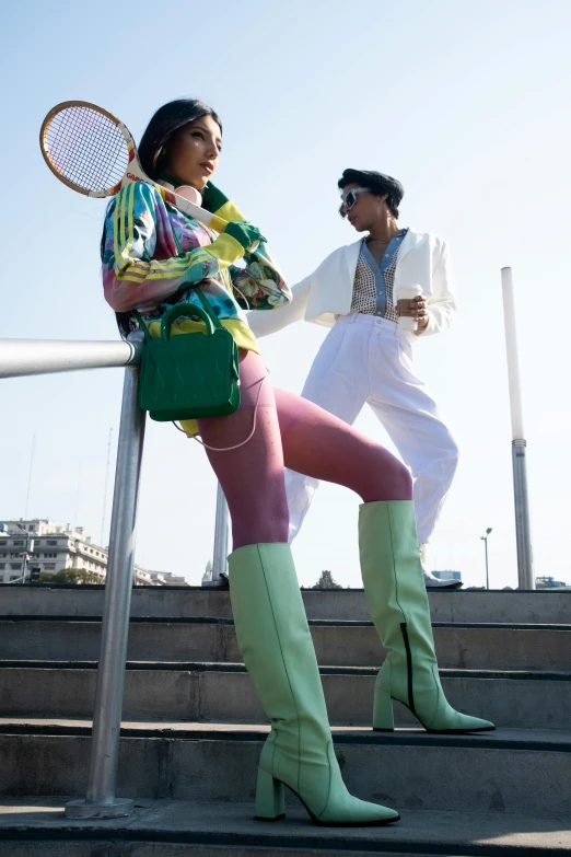 a woman standing with a tennis racket near another woman