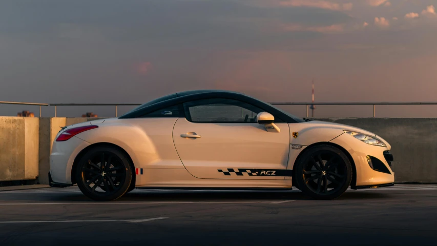 a white car is parked outside by a wall