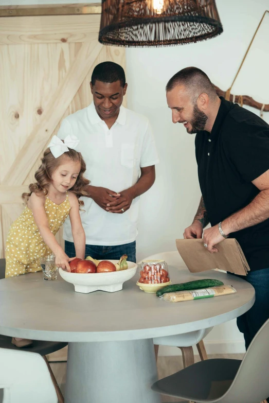 the two people are making some treats for the girl