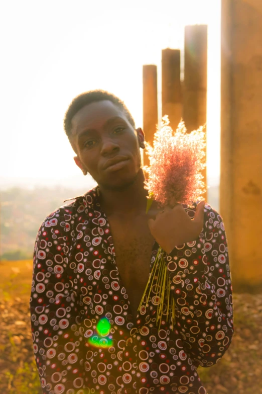 a man wearing a shirt and a flower is holding soing